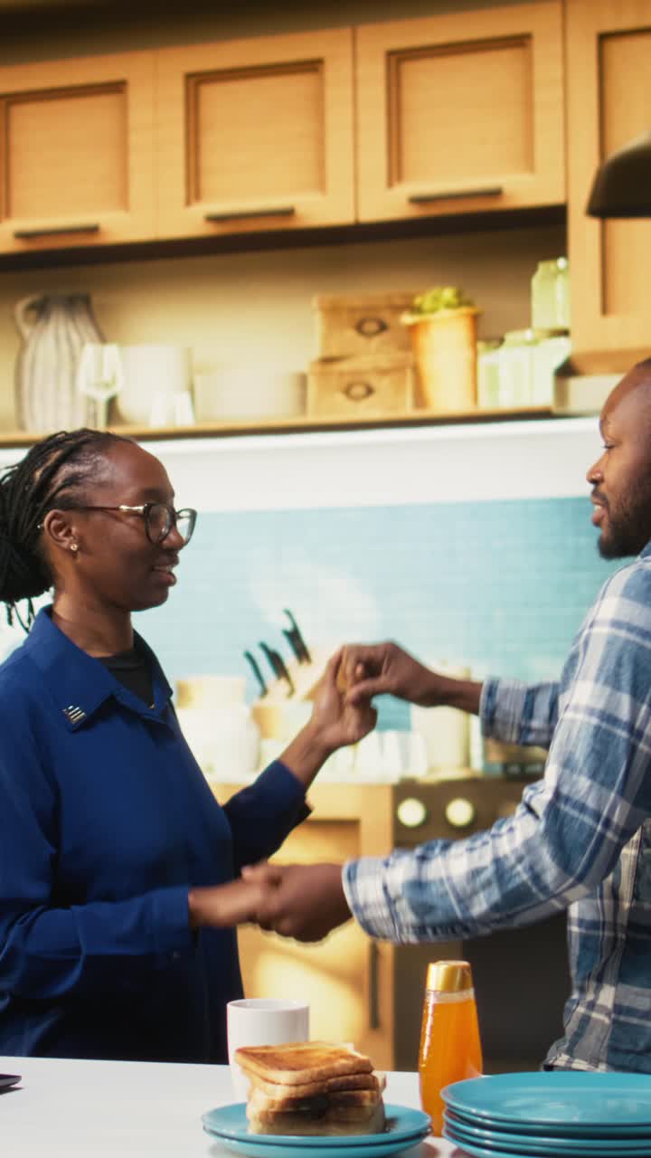 Vertical Video Romantic young black couple sharing a cute dance in the kitchen