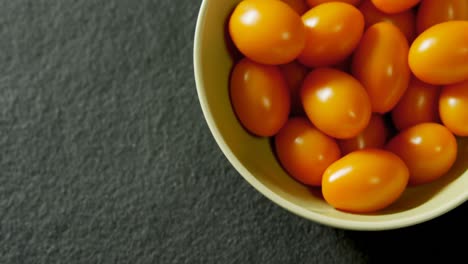 Tomatoes-in-bowl-on-grey-background-4K-4k