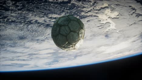 old soccer ball in space on earth orbit