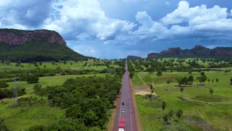 a wide road in the middle pantanal, the brazilian cerrado with a big mountain