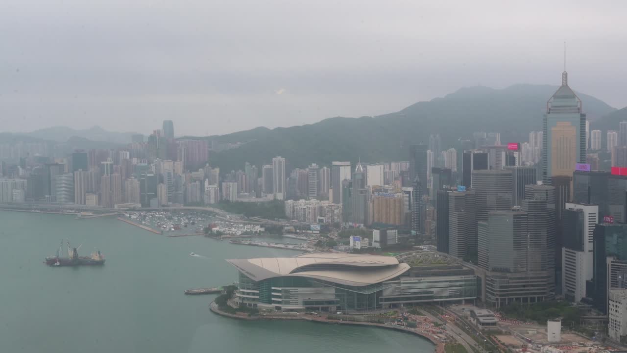 Aerial city view during a foggy dat of Hong Kong's financial district, skyline and skyscrapers at one of the most densely populated places in the world