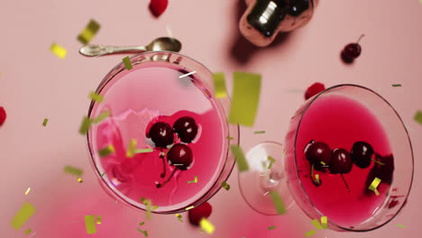 Animation-of-confetti-falling-and-cocktail-on-pink-background