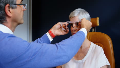 optometrist examining patient eyes with eye test equipment 4k