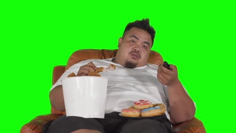 fat man eats fried chicken and looks sleepy