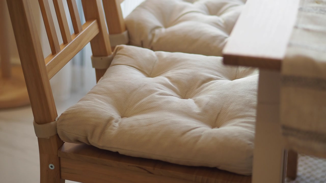 Close-up of a Wooden Chair with a Beige Cushion