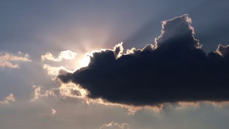 timelapse: sun beams shining through moving dramatic white clouds