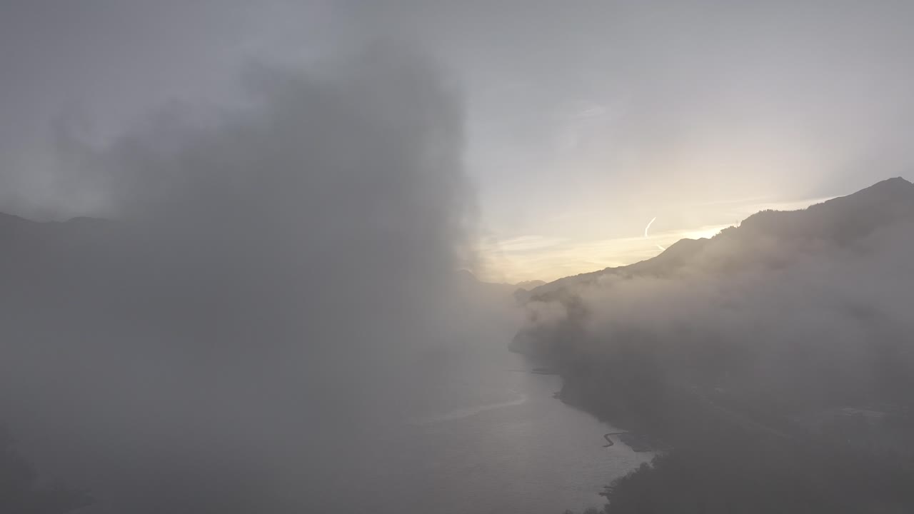 드론이 구름 위를 날아다니며 아래의 멋진 스위스 알프스 산맥을 드러니다.