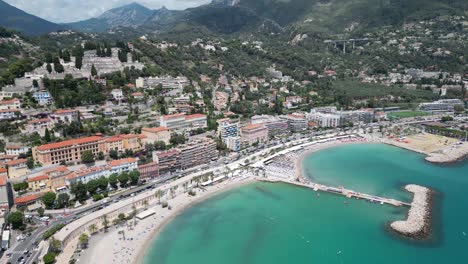 Soleil-bay-at-seaside-town-of-Menton-in-French-riviera,-Aerial-pan-right-shot
