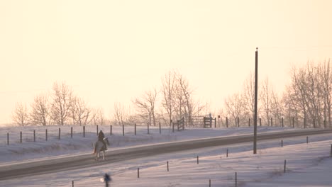 Horse-riding-on-a-winter-snow-day-during-the-sunset-in-slow-motion