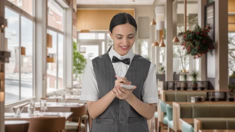 happy indian woman waiter taking food order