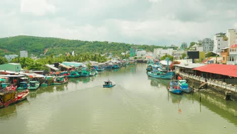 Kleines-Holzboot,-Das-Einen-Fluss-In-Einem-Tropischen-Malerischen-Schwimmenden-Dorf-Segelt