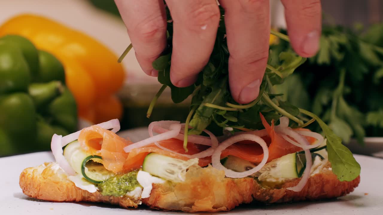 Croissant with jamon ham, Salmon, in Modern Cafe, Top View of Healthy Breakfast in Cafe. English breakfast: fried egg, bacon toast on sandwich.