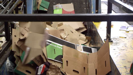cartón para reciclaje que se mueve en cinta transportadora, disparado en r3d