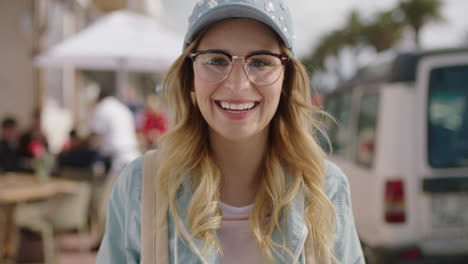 Retrato-De-Una-Hermosa-Y-Linda-Mujer-Rubia-Sonriendo-Alegre-Con-Gafas-Disfrutando-De-La-Soleada-Playa