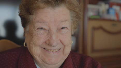 elderly woman's joyful expression looks into the camera, close-up