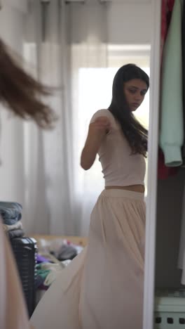 woman trying on clothes in front of a mirror