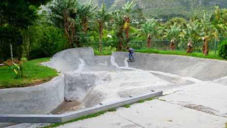 Side-view-of-young-caucasian-man-practicing-skateboarding-on-ramp-in-skateboard-park-4k