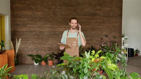 plant shop owner talking on the phone