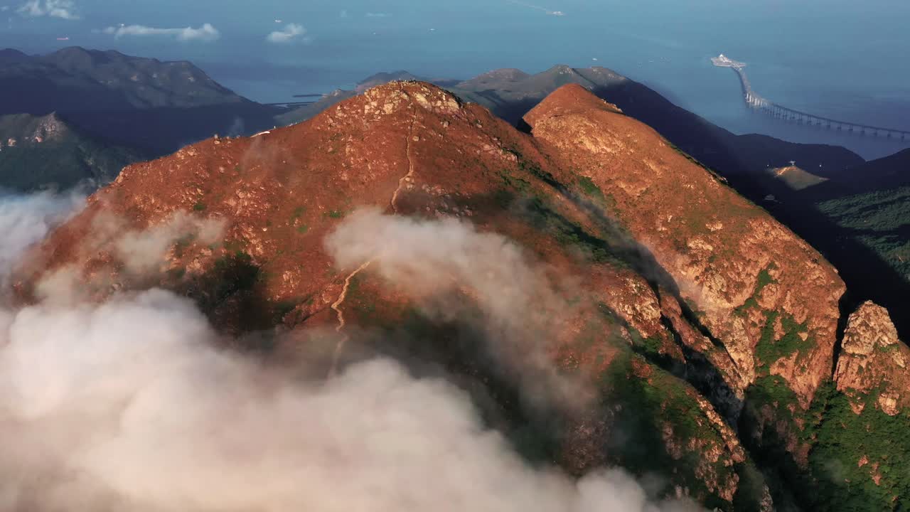 Moody landscape on Lantau island in Hong Kong 4k sunrise. Landscape of Lantau Island, Hong Kong, China.The ridge of the Lantau peak (960m) in Lantau island, the largest island in Hong Kong