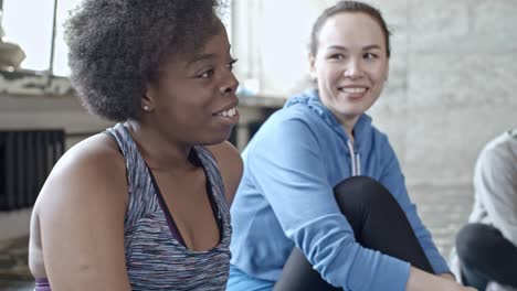 woman talking with female friends in fitness class