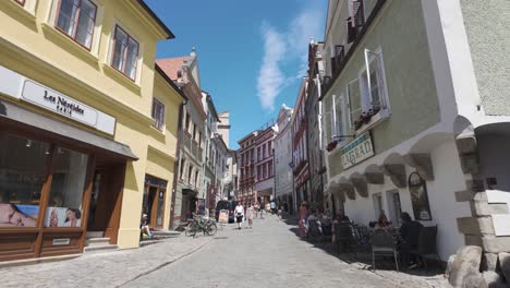 charming street scene in český krumlov, czechia, with colorful historic buildings on a sunny day