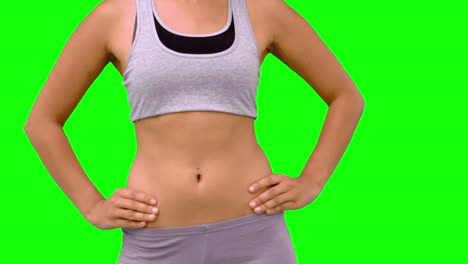 Athletic-woman-turning-to-camera-against-green-screen