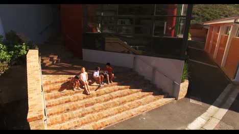 school kids sitting at school staircase