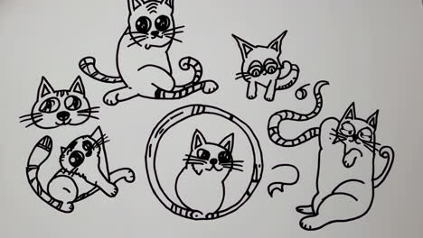 collection of black and white cartoon cat drawings