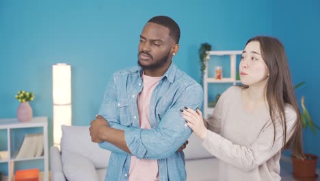 Asian-woman-comforts-her-african-husband-about-his-problem.