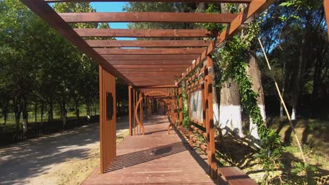 Eye-Level-Hyperlapse-Shot-of-Wooden-Archway-Walkway-Through-Hanshiqiao-Wetland-National-Park,-Beijing,-China