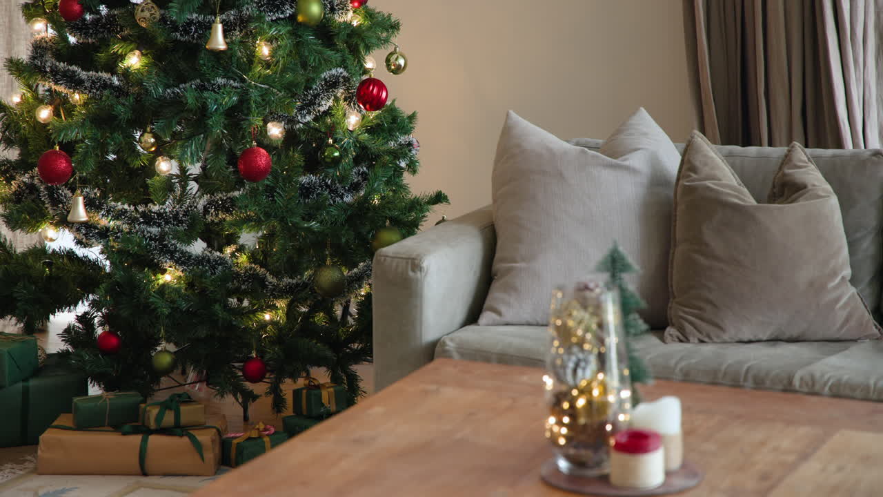 Cozy living room with decorated Christmas tree and gifts under it, copy space