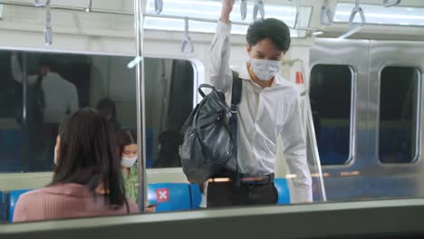 crowd of people wearing face mask on a crowded public subway train travel