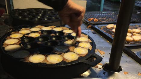 cooking concept. kind of thai sweetmeat . coconut milk mix with powder fried dessert at thai night street food market. dessert of thai traditional sweetmeat, pancake, pudding. 4k footage.
