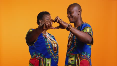 african american couple doing heart shaped sign