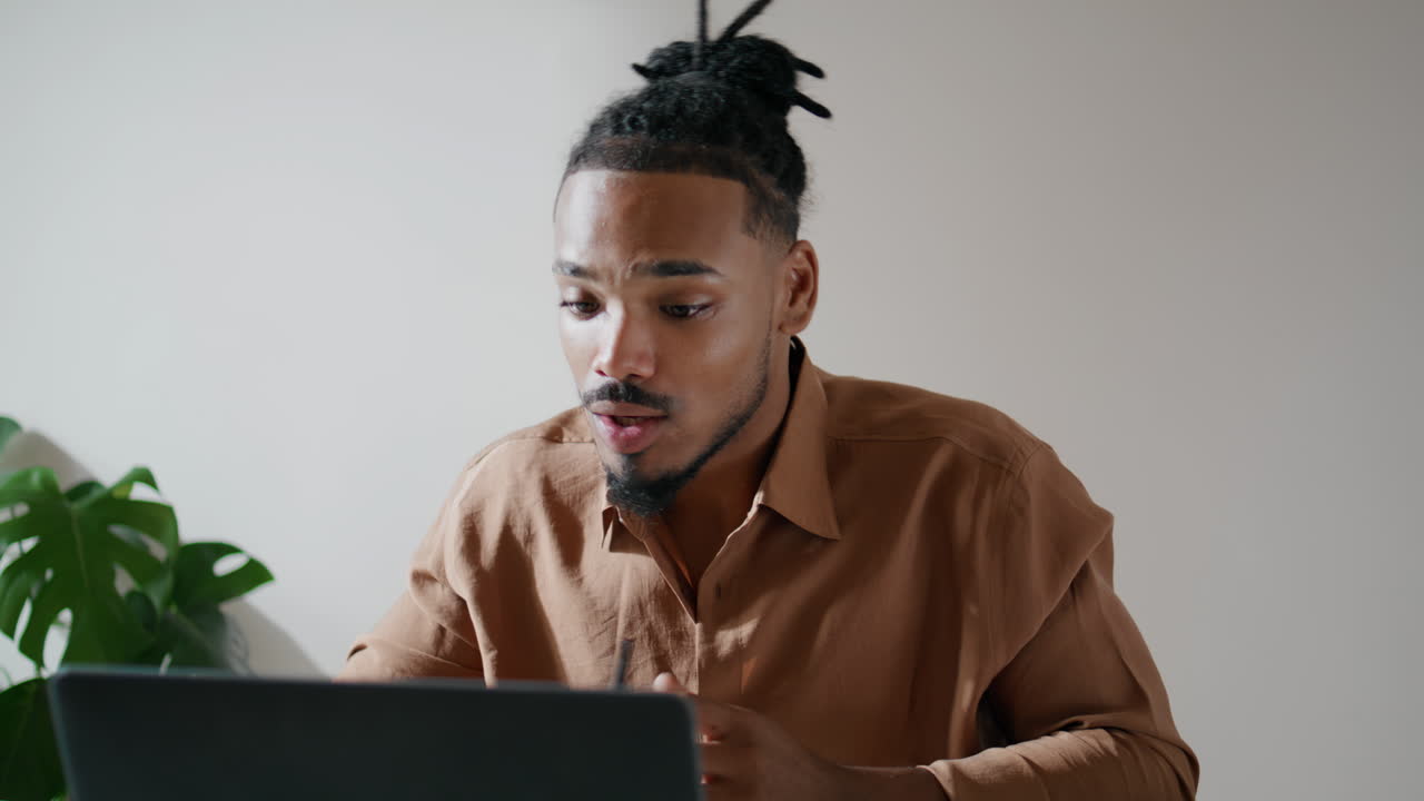 Smiling freelancer talking clients online at flat closeup. Man using laptop call