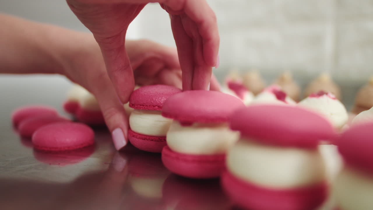 Woman making filled macarons