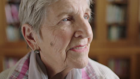 portrait-of-pensive-elderly-woman-looking-out-window-smiling-contemplative-thinking-of-memories