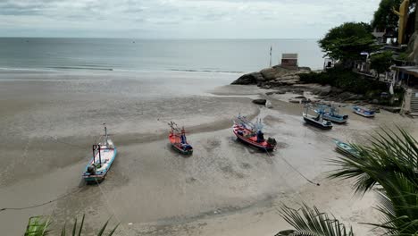 palm trees and fishing boats on thailand beach