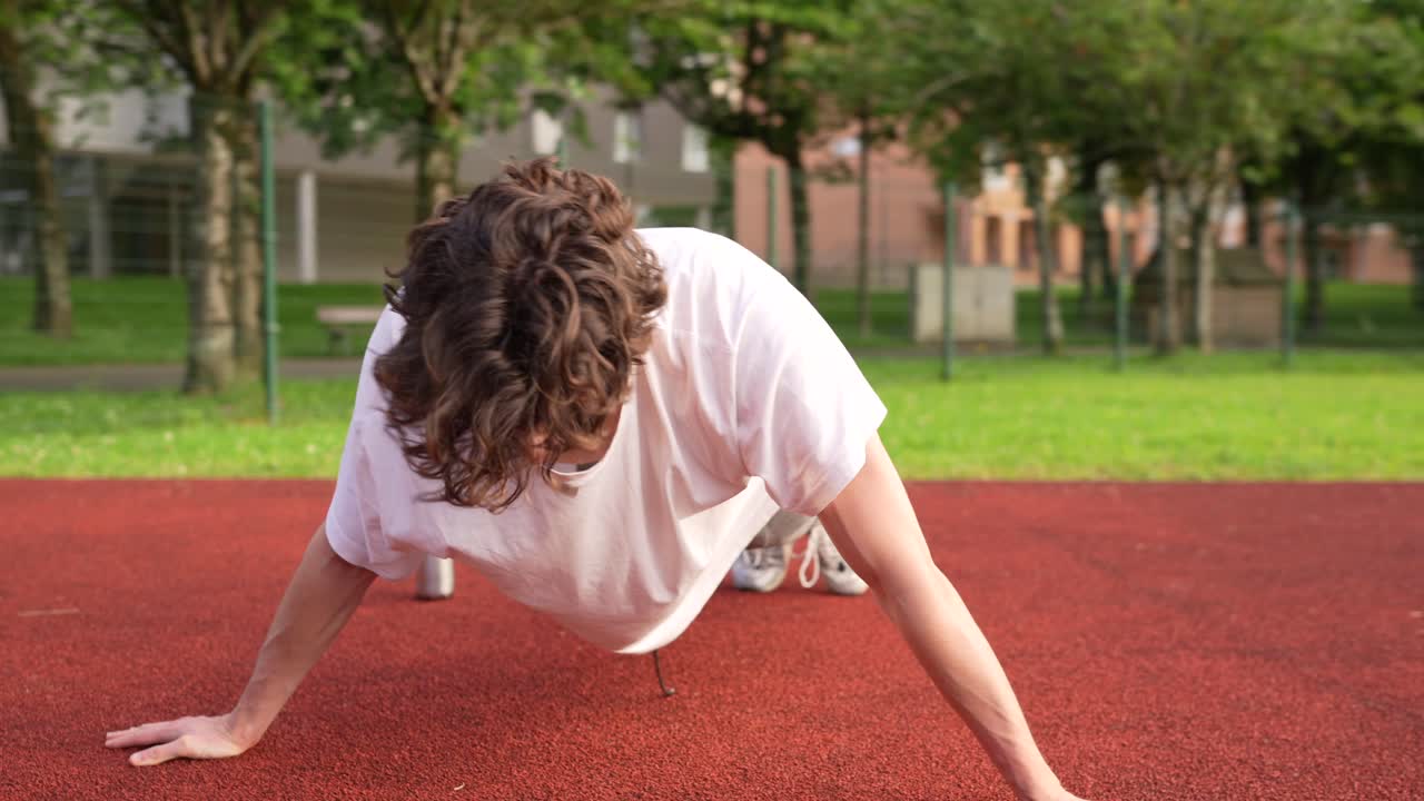 Man doing push-ups on a track