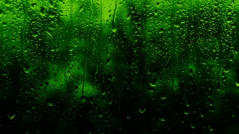 rainy background in neon green color, drops flow down the glass, copy space background. the texture of raindrops on the glass