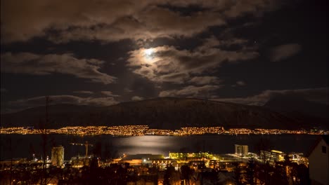 night cityscape with moon and clouds