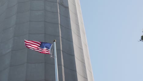 American-National-Flag-Waving-on-Pole-Under-Coit-Tower,-San-Francisco-California-USA