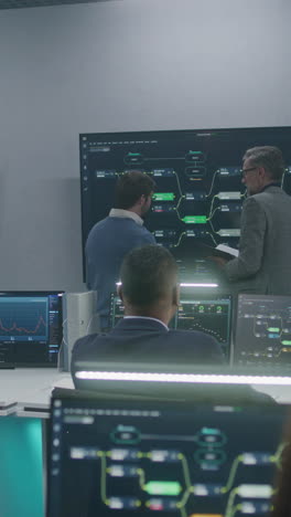 it professionals analyzing data in a high-tech control room