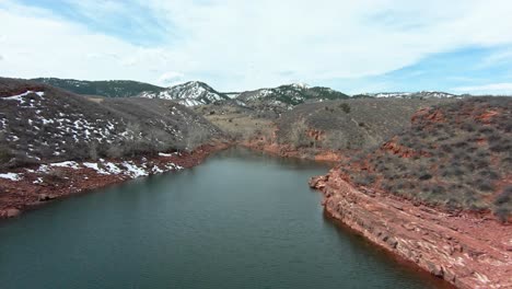 overflying a stretch of river with large rock formations in the background