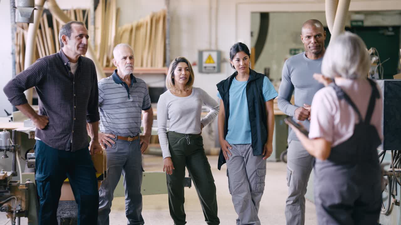 Diverse Group of Workers Listening to a Speaker in a Workshop