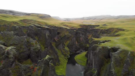 rugged moss rock cliffs of fjadrargljufur canyon in nordic iceland