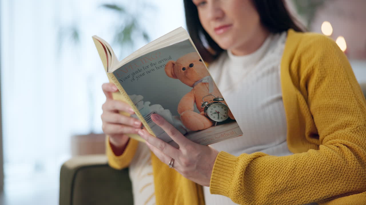 Woman reading a pregnancy guide book