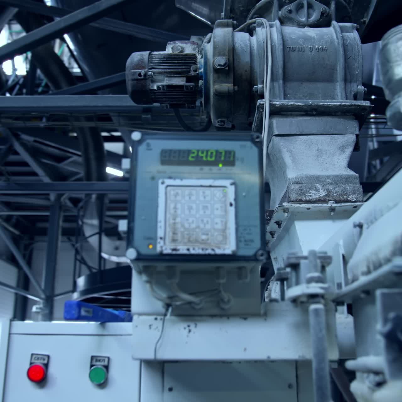 Industrial equipment with metal box and counter. Electric engine attached to the tubes at the backdrop of metal ceiling. Counter close up