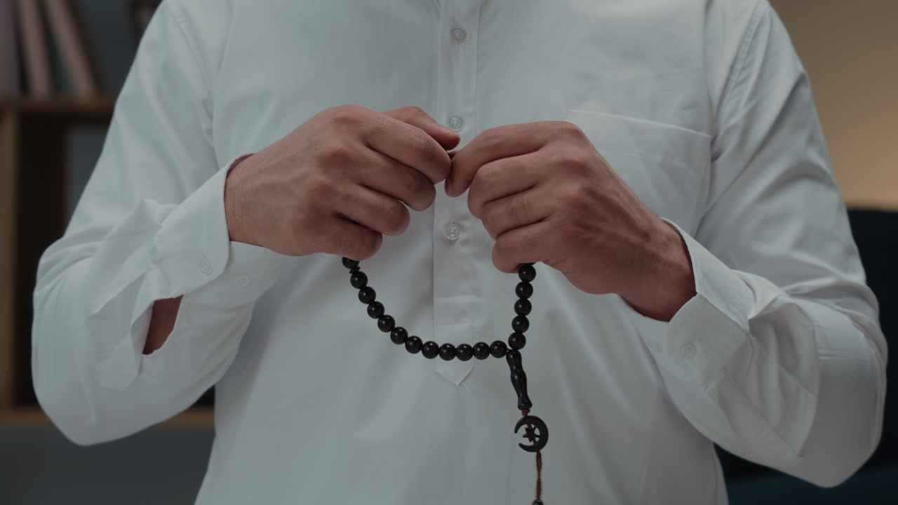 Close-up of hands holding prayer beads