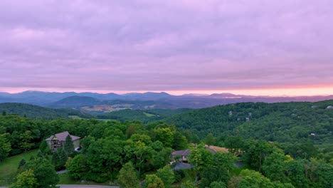 aerial-rising-over-vacation-homes-at-sunrise-near-boone-nc,-north-carolina